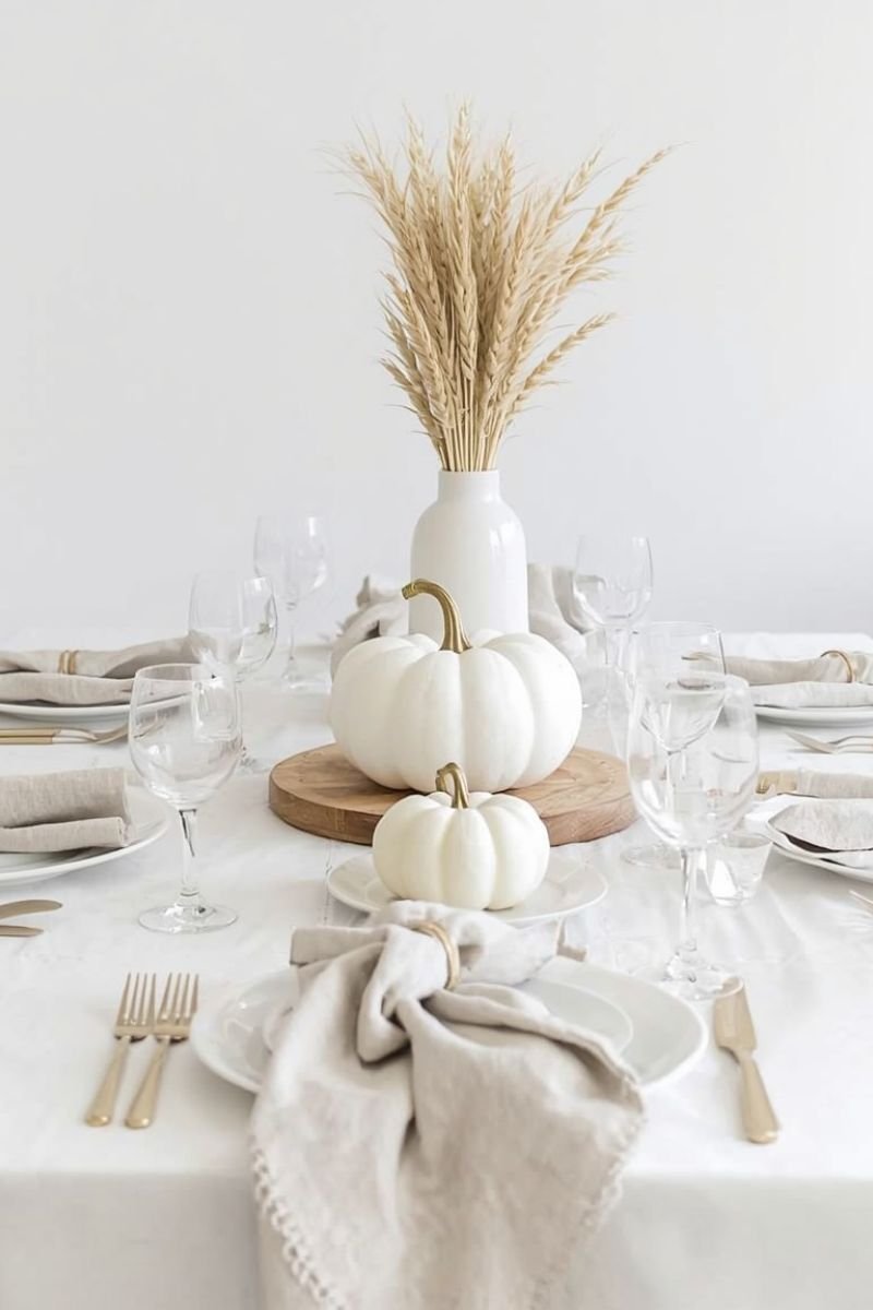 All white natural linen modern Thanksgiving tablescape white pumpkin pampas wheat