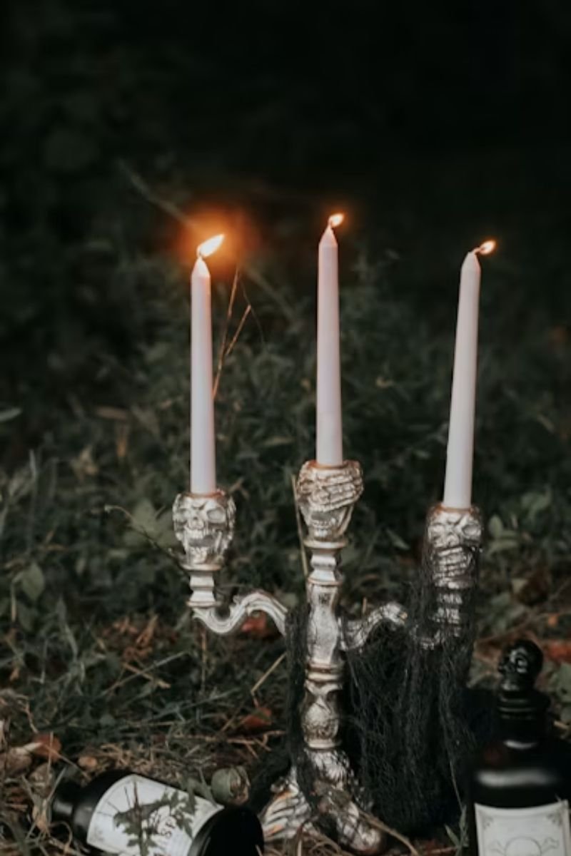 Antique brass candelabra dripping wax ivory candles dark mirror elegant Halloween