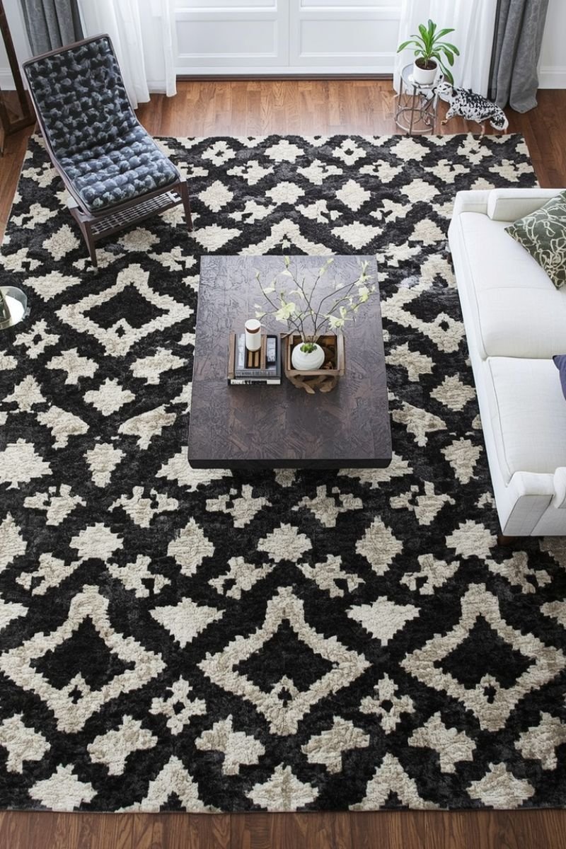 Black and white geometric patterned rug anchoring a Neo Deco living room seating area