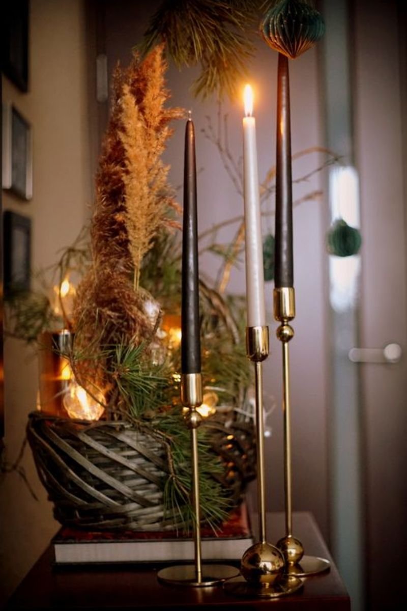Black taper candles mismatched brass holders elegant Halloween tablescape centerpiece
