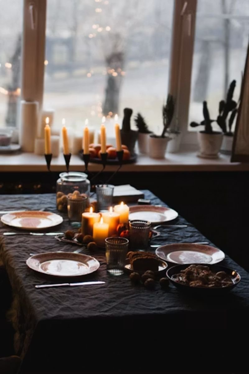 Bone white serving dishes platters black tablecloth elegant Halloween dinner table
