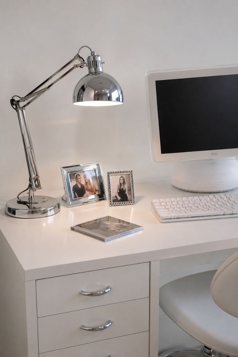 Chrome desk lamp and metallic accents on white Y2K bedroom desk