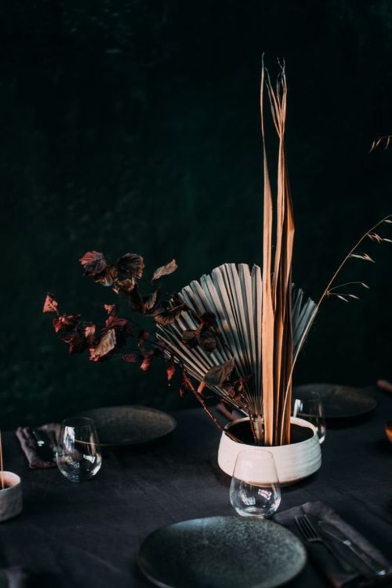Dark linen napkin single dried lavender stem black feather elegant Halloween place setting
