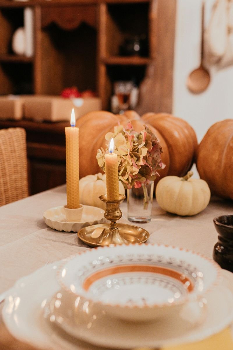 Deep burgundy gold traditional Thanksgiving tablescape dahlias candles charger plates