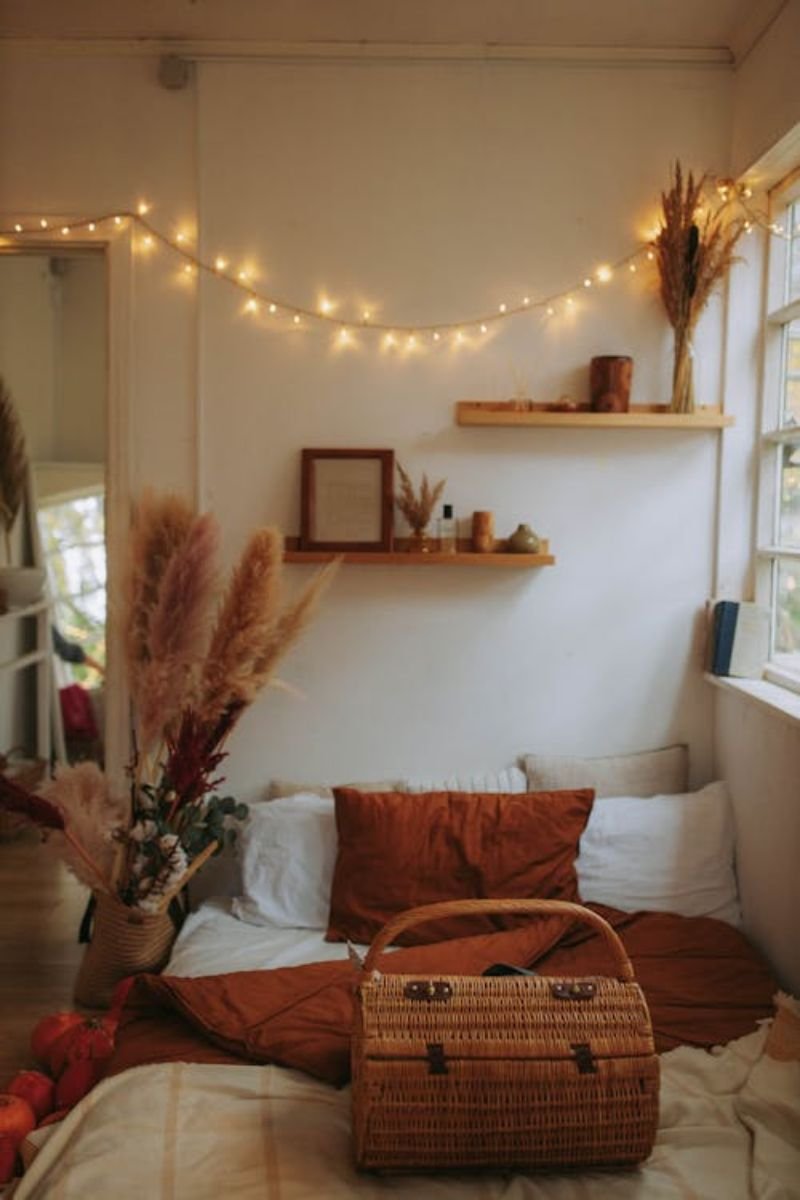 Dried fall leaf garland above bed headboard bedroom autumn decor