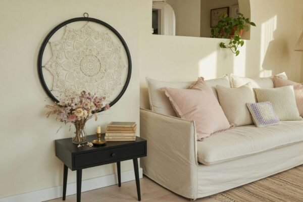 Framed white doily on living room wall with dried flowers and vintage books