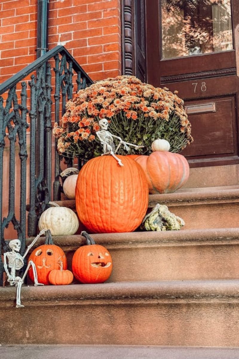 Front porch layered pumpkins varying sizes white orange fall decor 2026
