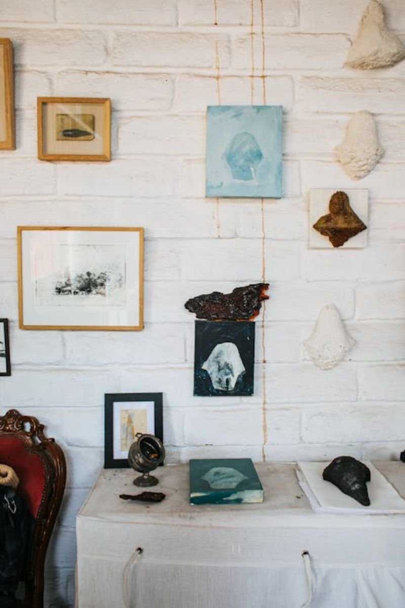 Gallery of framed coastal and nautical wall art on a porch