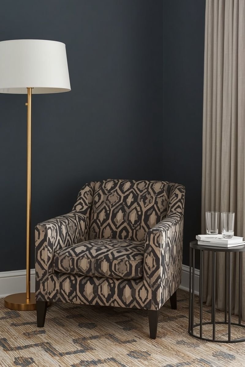 Geometric print accent chair next to brass floor lamp in a Neo Deco living room corner