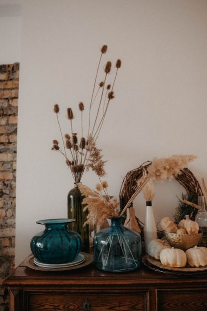 Glass and brass coastal porch accessories with hurricane vases