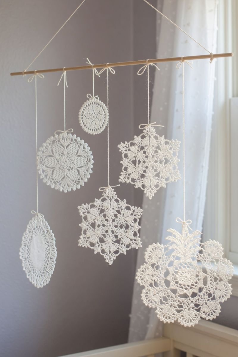 Hanging doily mobile made from a wooden dowel with white lace doilies