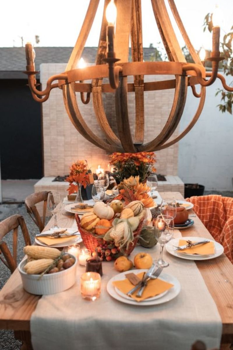 Harvest dining table centerpiece wooden board candles pumpkins pinecones eucalyptus