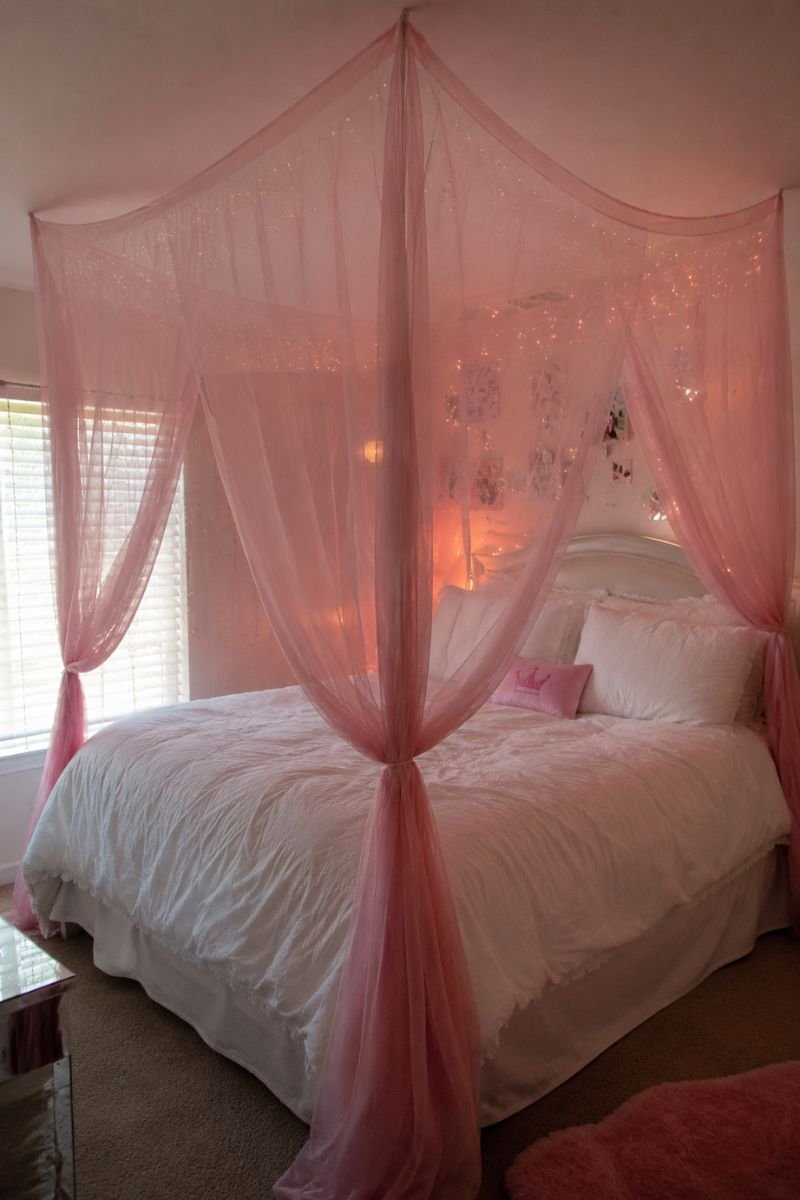 Sheer pink canopy over white bed in Y2K bedroom