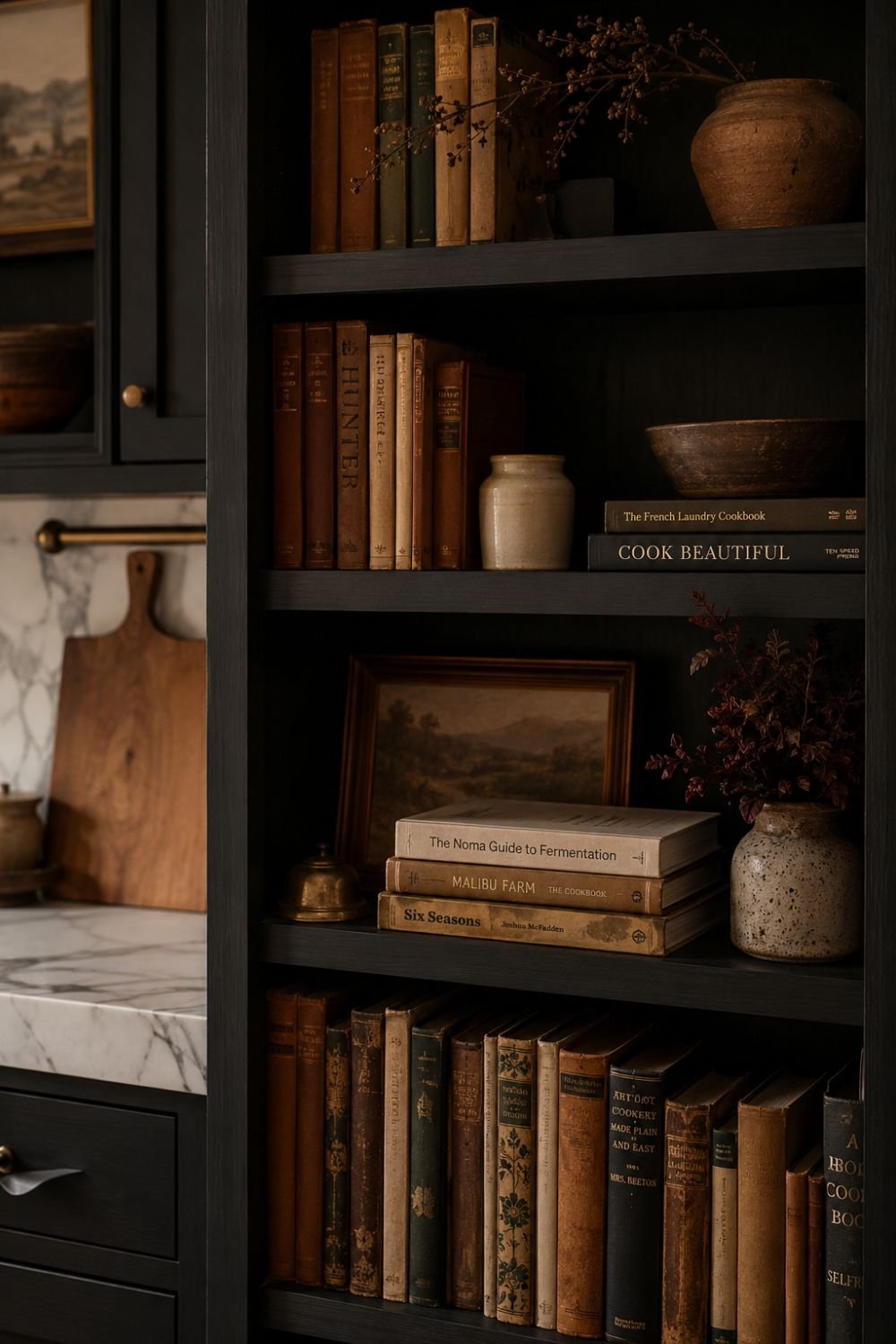 Cookbook and book display on dark kitchen shelves