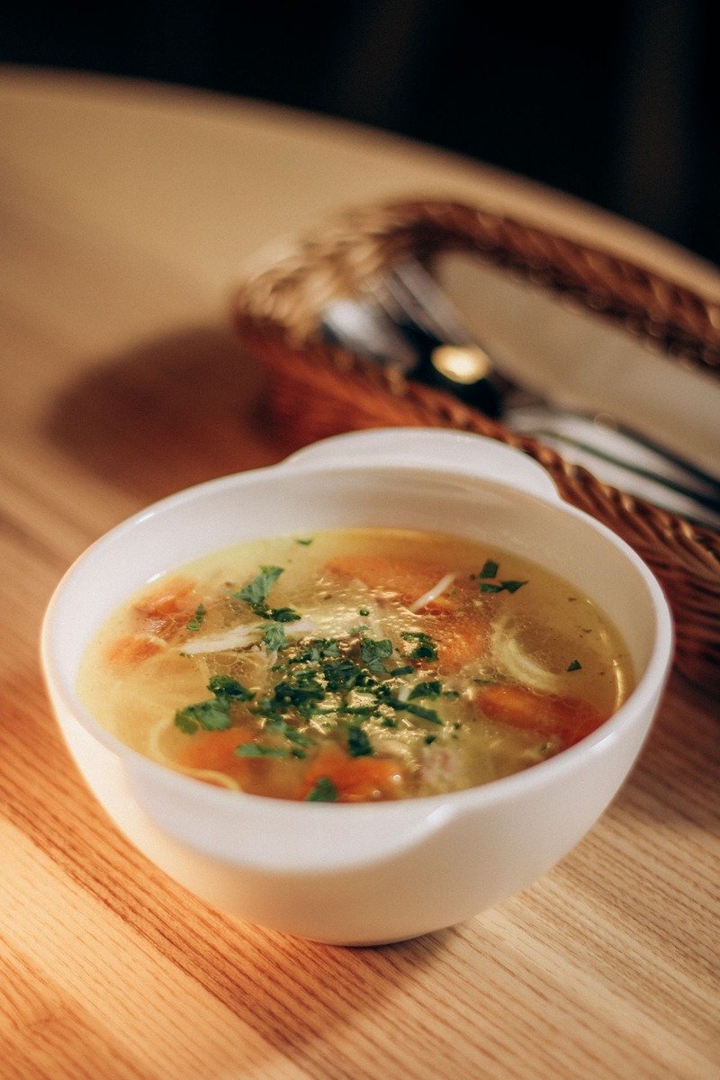 Bowl of chicken noodle soup with carrots