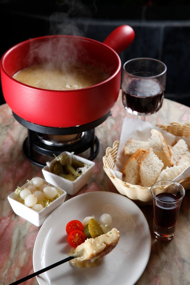 Cheese fondue pot with bread and dippers