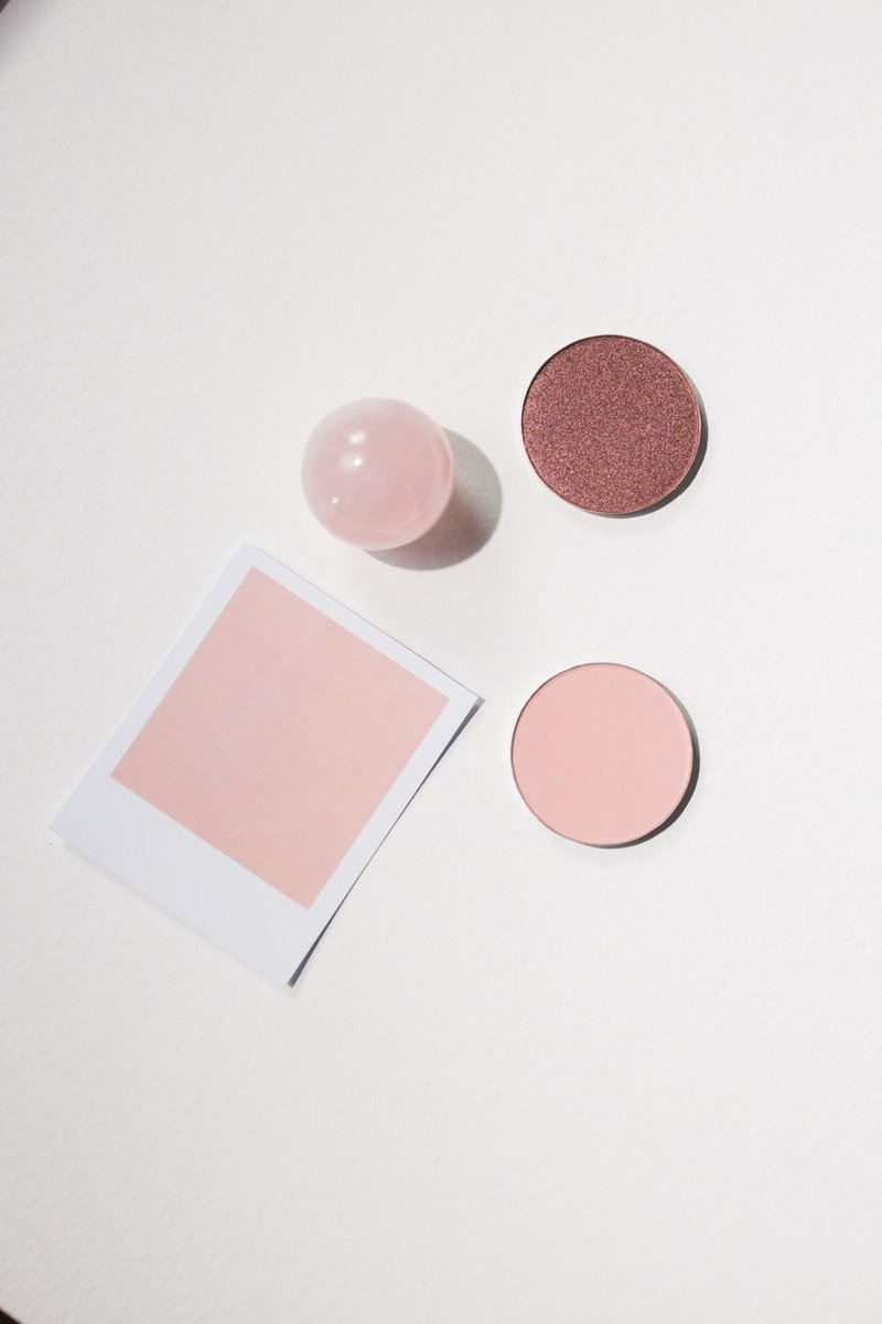 Matte dusty rose powder blush in a compact with brush
