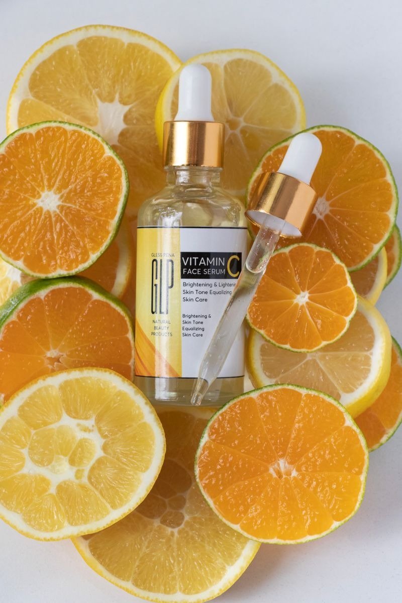 Bottle of vitamin C brightening body wash beside fresh orange slices