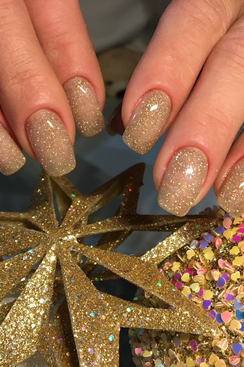 Almond nails with gold glitter fading from cuticle to tip
