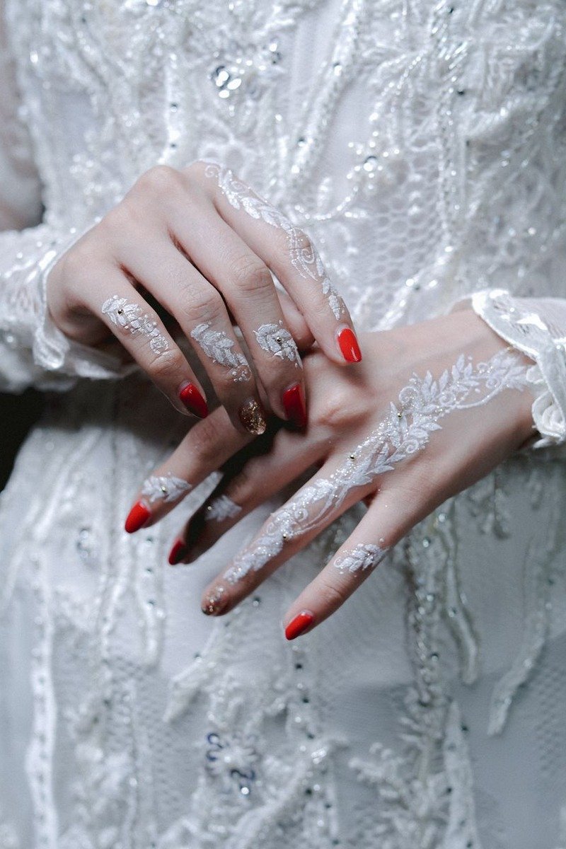 Sheer nude nails with white lace pattern overlay