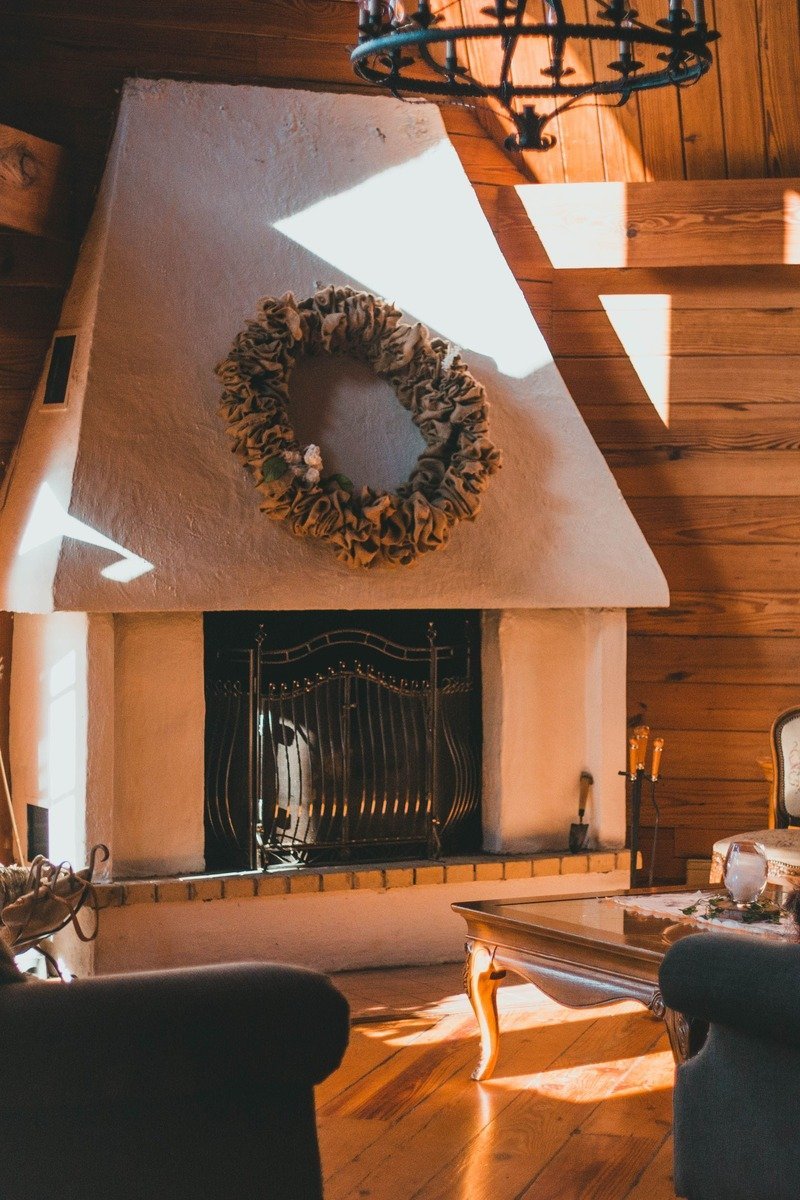 Cozy cabin living room with fireplace and bookshelves set up for a book club retreat weekend