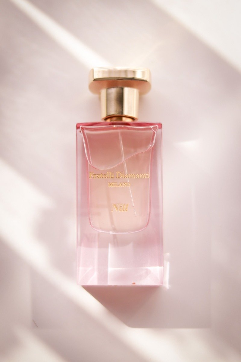 Pink Kayali-style marshmallow perfume bottle on a vanity