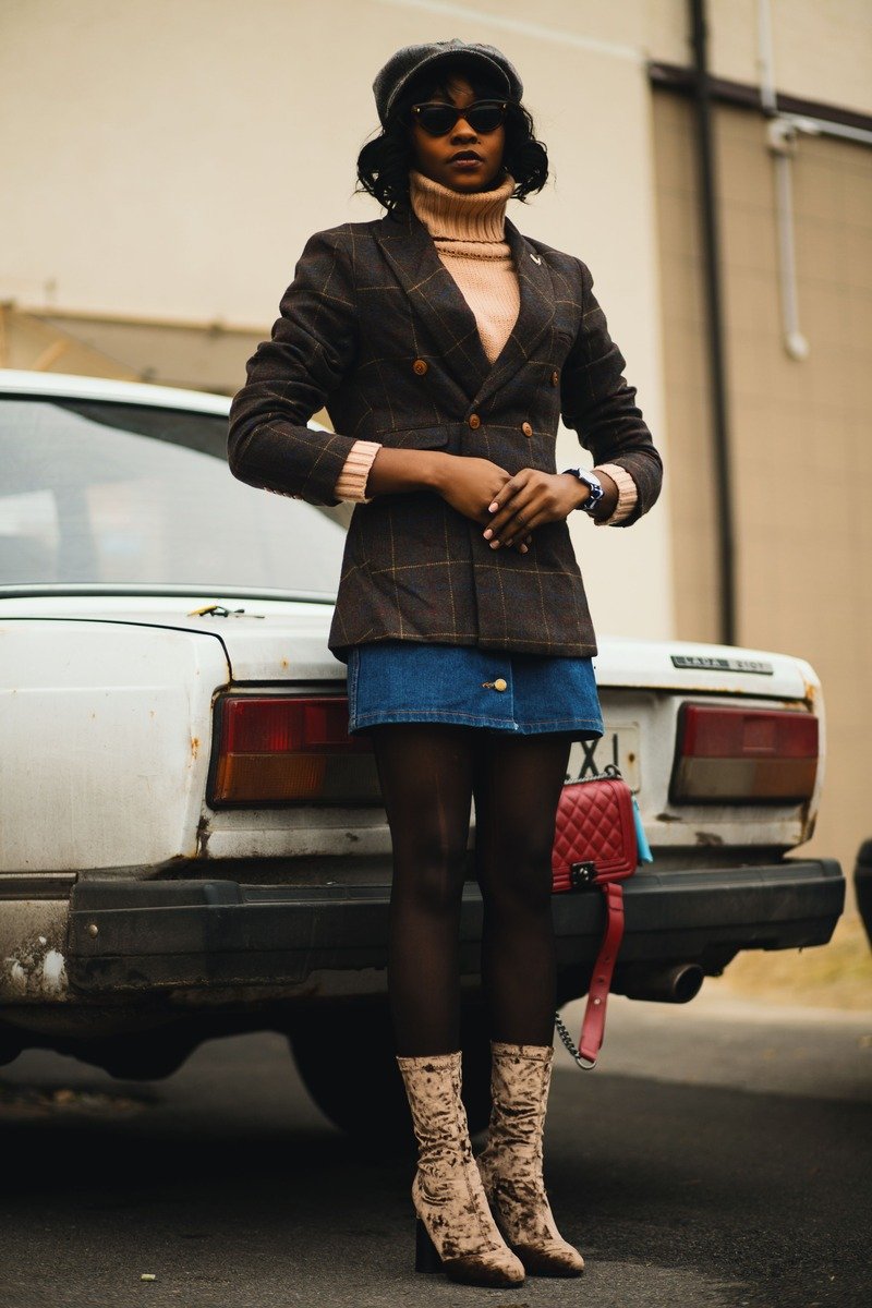 Woman wearing a wool blazer over a turtleneck with tailored trousers at the office