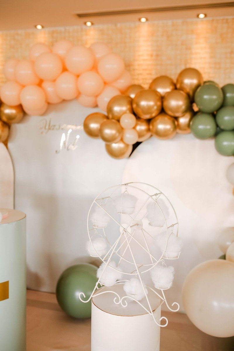 Colorful balloon garland arch over a birthday party table