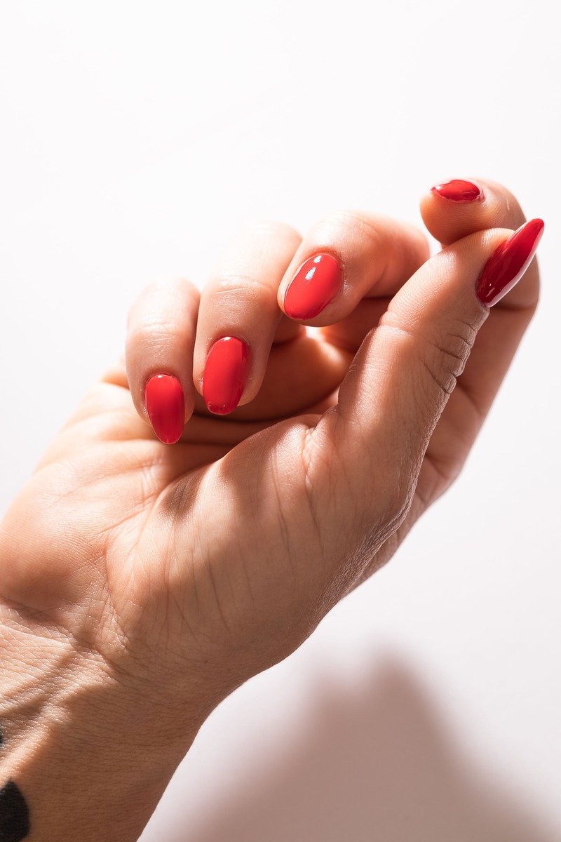 Classic glossy red manicure on almond nails