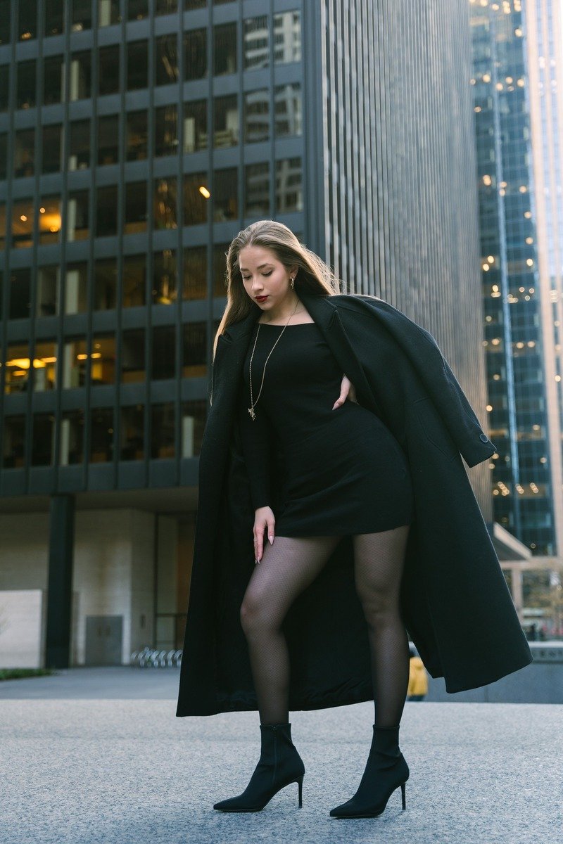 Woman in a little black dress with tights winter date night outfit