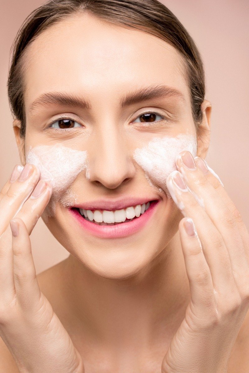 Woman cleansing her face in the morning