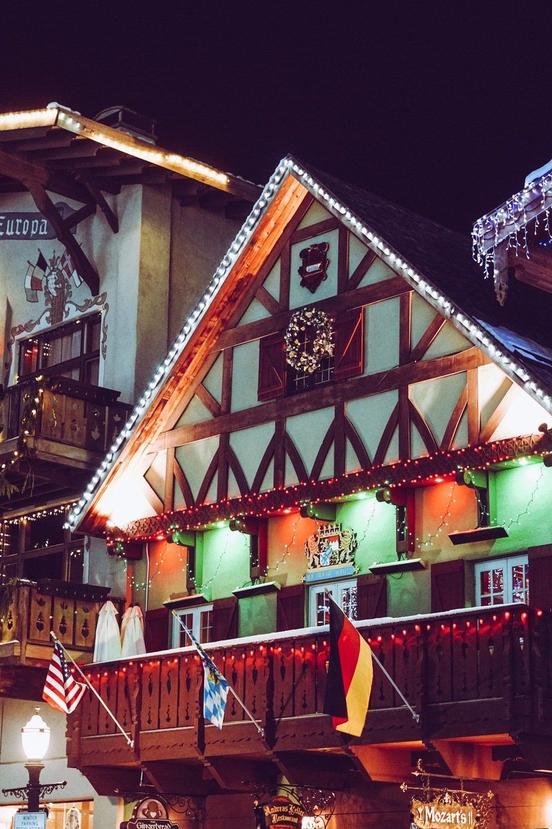 Hotel Europa and half-timbered Bavarian buildings on Leavenworth's Front Street glowing with Christmas lights at night