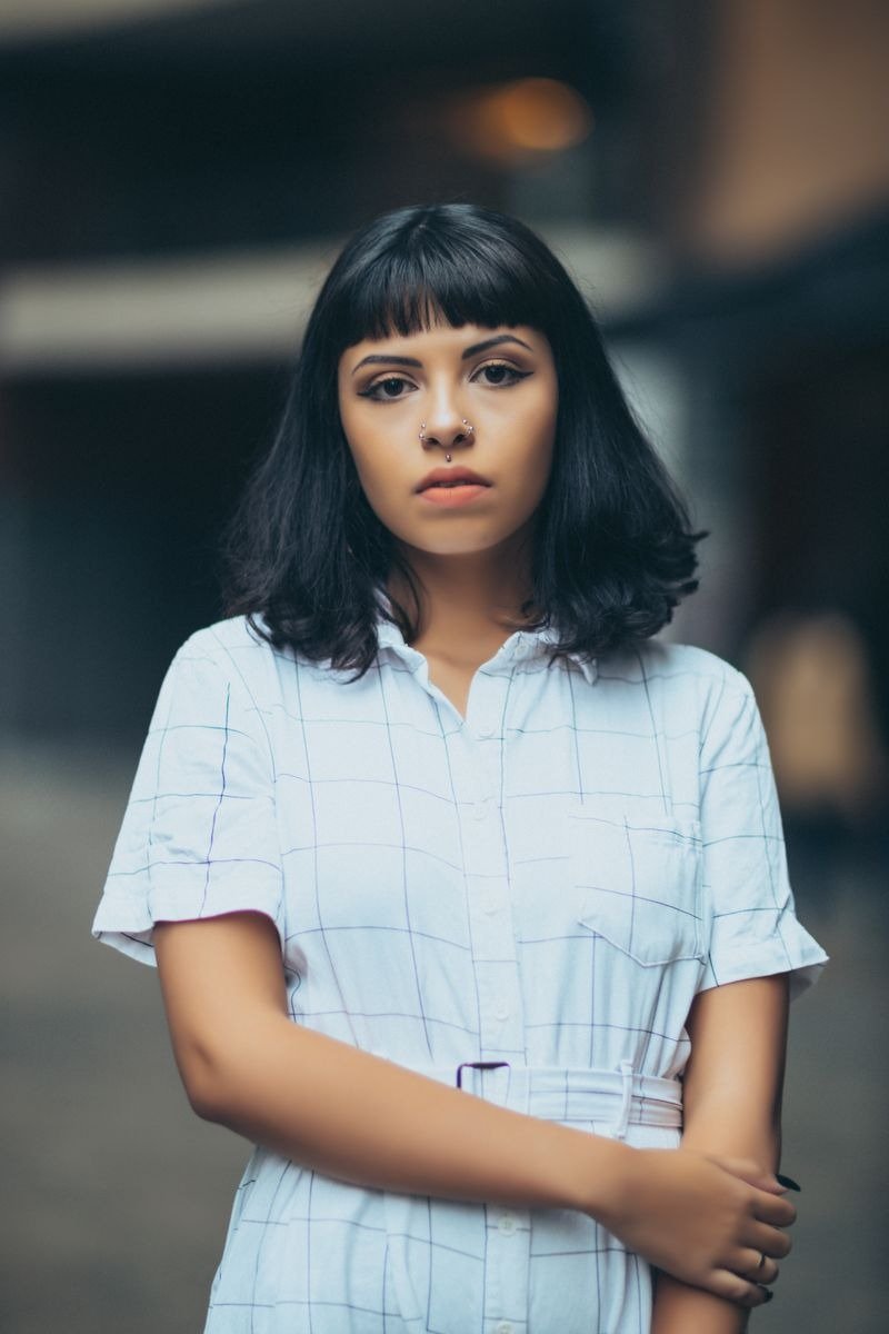 Long layered bob with curtain bangs framing the face softly