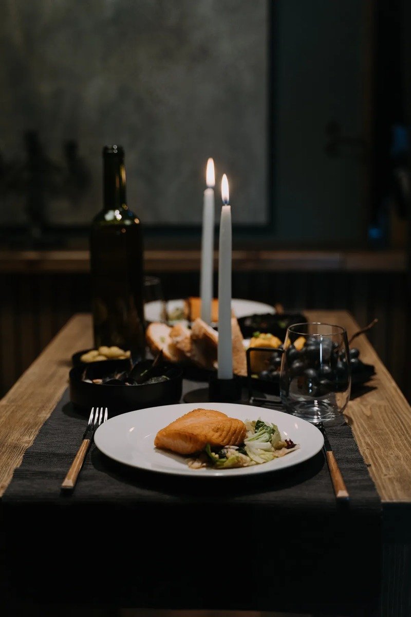 Elegant dinner table styled around a book theme with literary place cards and candles