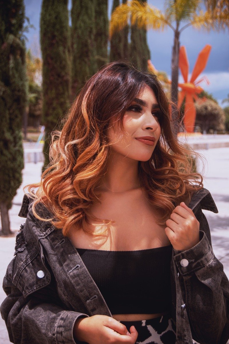 Cherry cola balayage with hand-painted red tones on dark hair