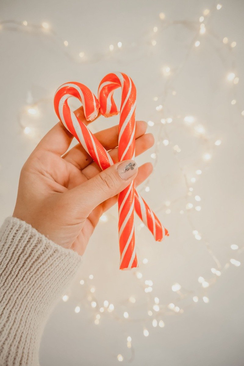 Candy canes held in a hand as advent calendar fillers