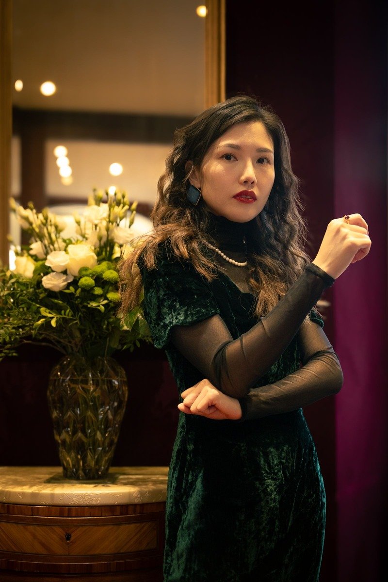 Woman in a green velvet dress outfit