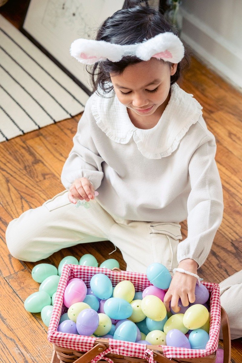 Child holding an easter basket of colorful plastic eggs