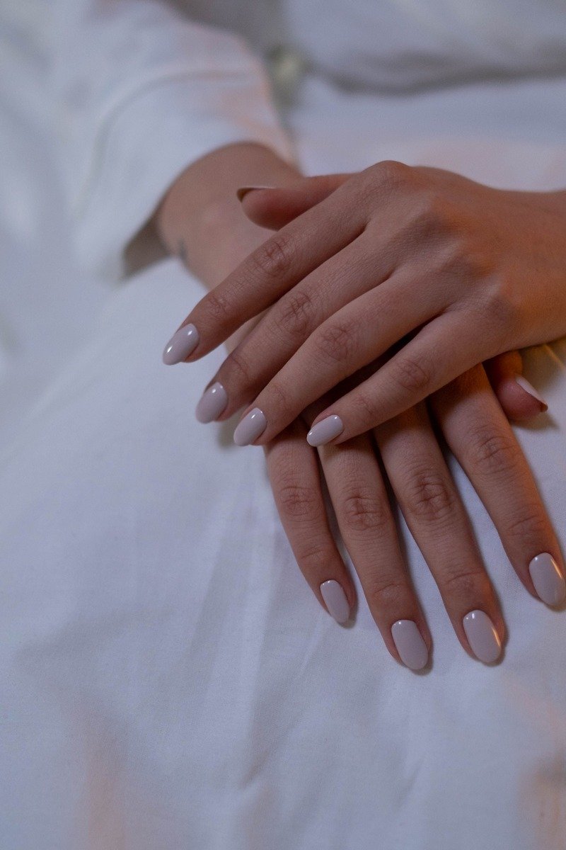 Short nude january nails with a glossy finish