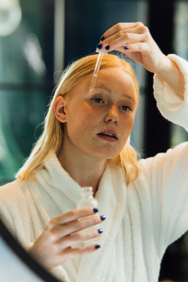 Applying face serum with a dropper