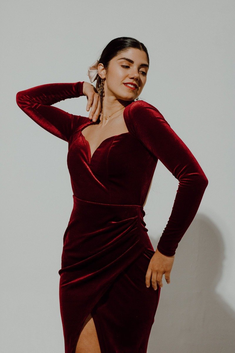 Woman in a burgundy velvet midi dress