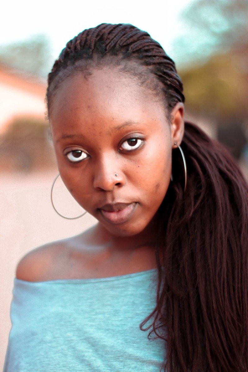Fine twists in a low ponytail on a Black woman