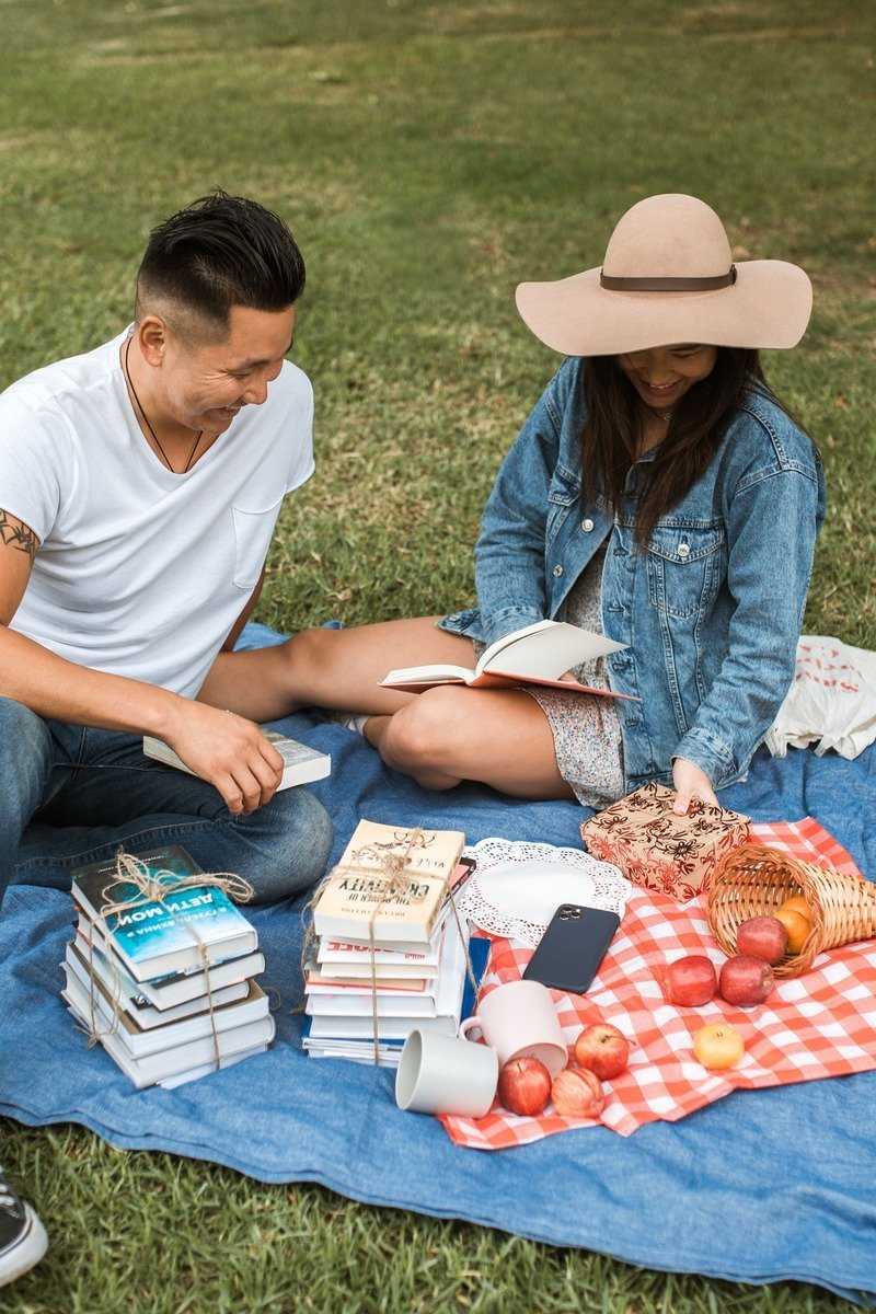 Outdoor reading circle with blankets and cushions arranged under trees for a book club
