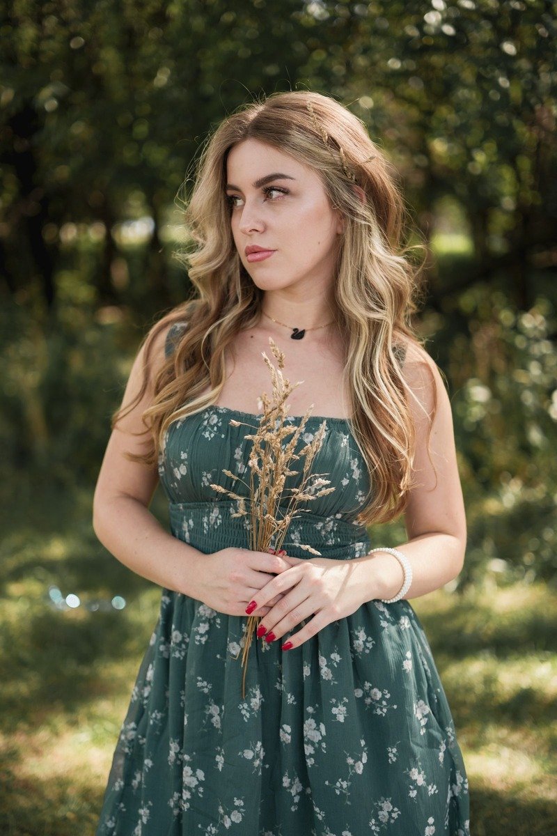 Woman in a green floral dress outfit