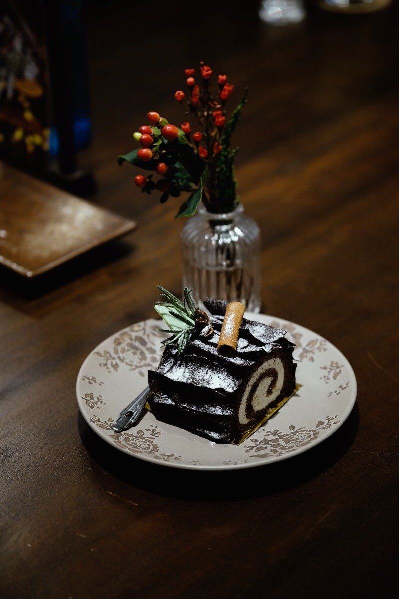 Slice of chocolate yule log cake showing the cream spiral