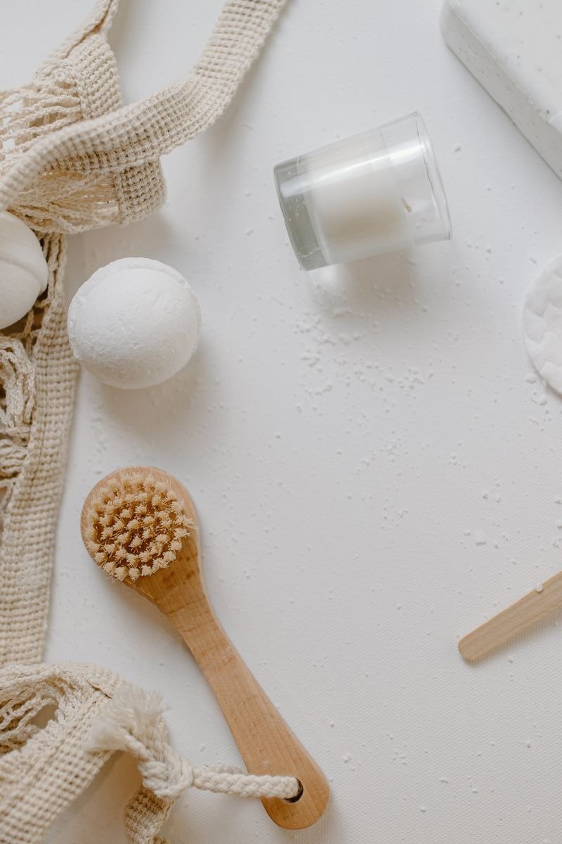 Citrus body wash with lemon and grapefruit halves on a bathroom counter