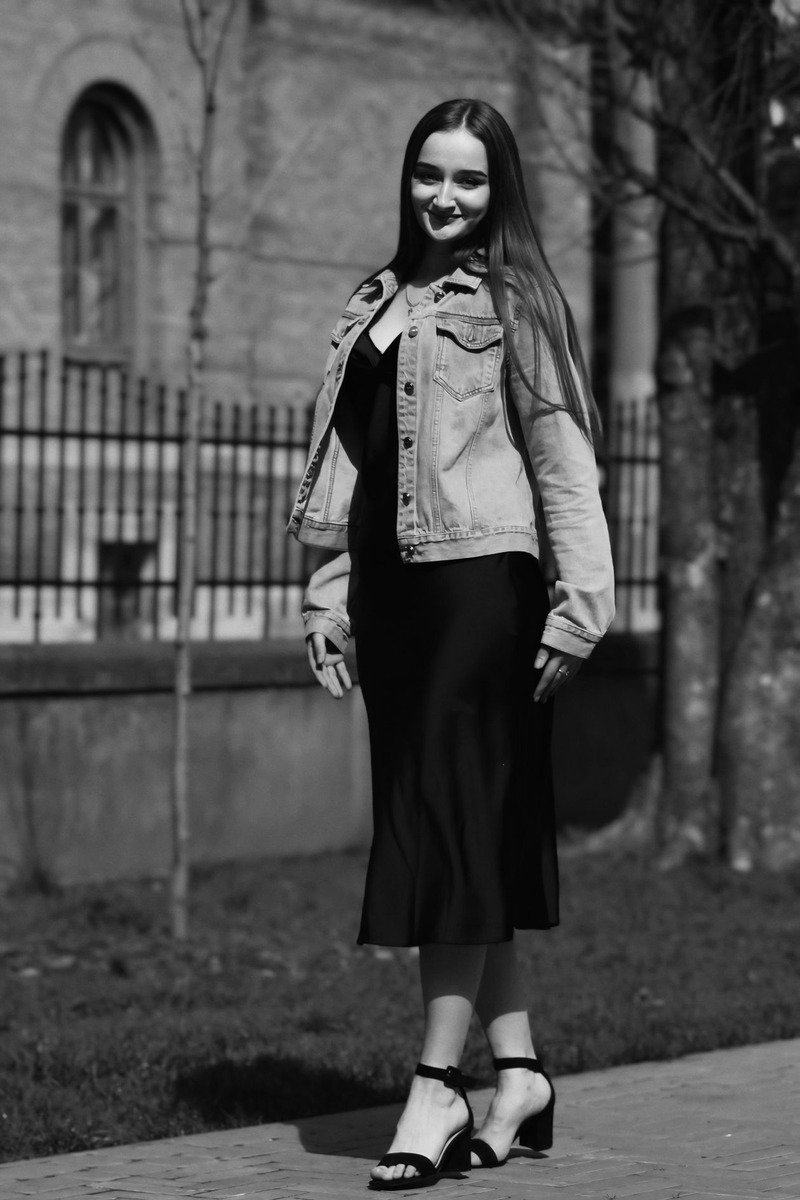 Mom wearing a black dress layered with a denim jacket