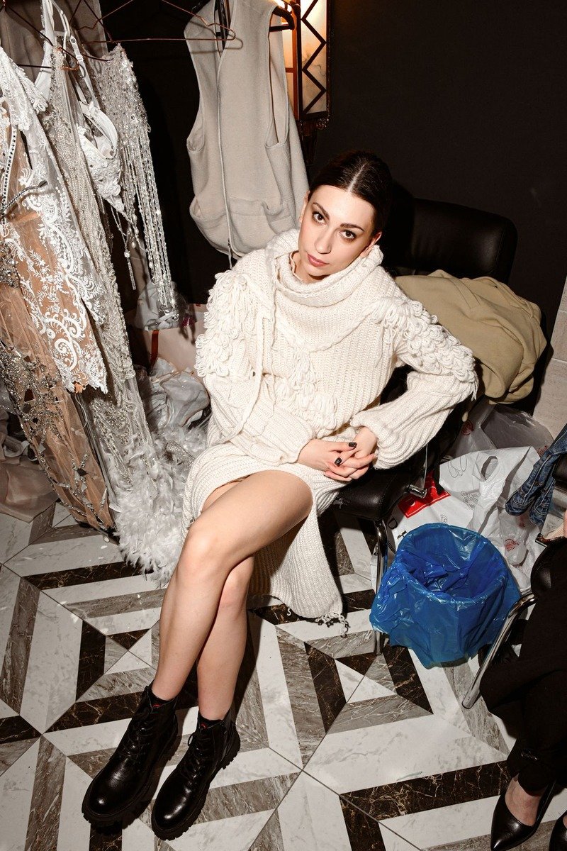 Woman in a sweater dress and ankle boots in winter