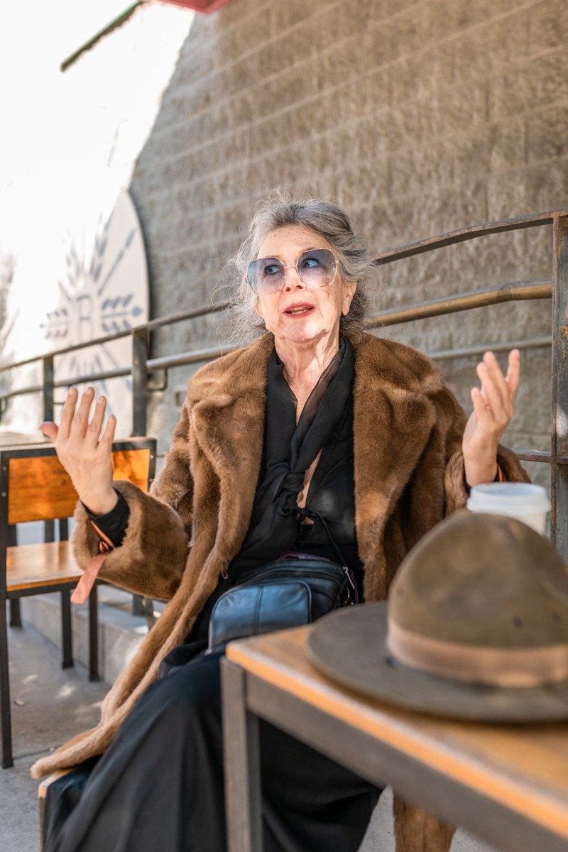 Woman over 50 in a long brown fur coat