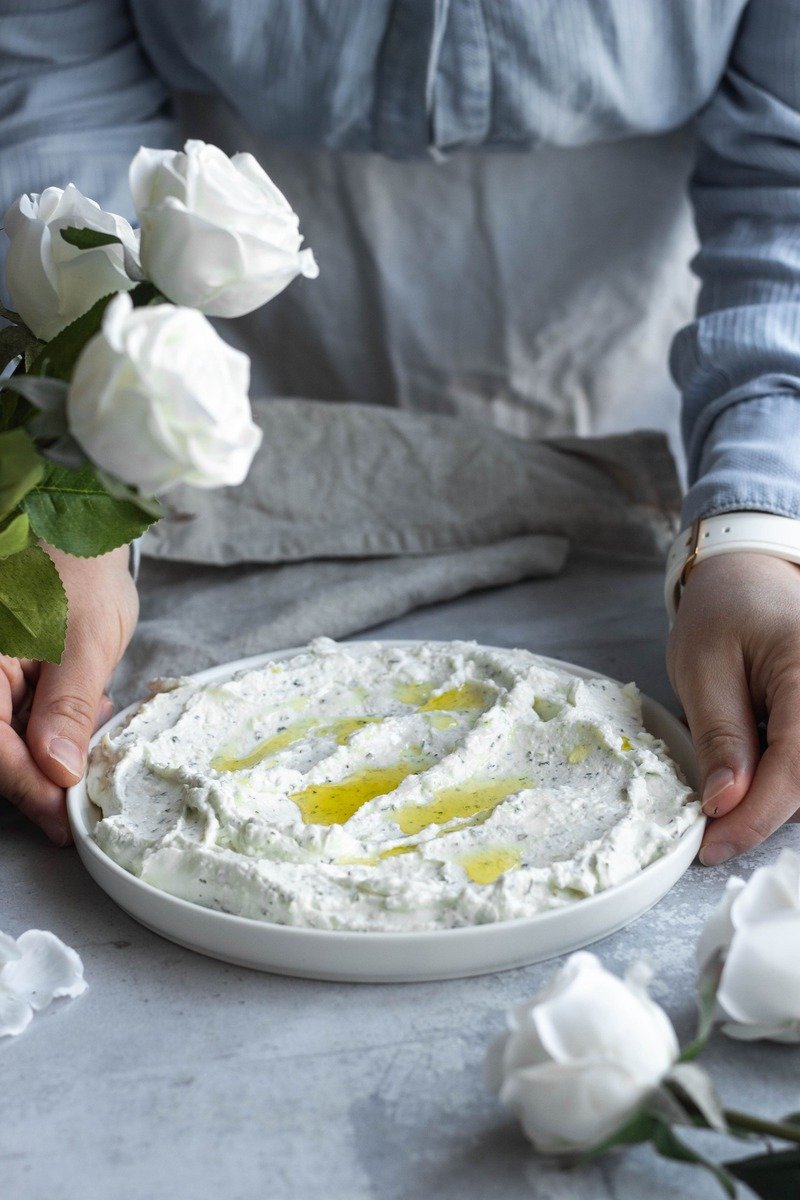 Whipped feta dip with a honey drizzle in a small bowl